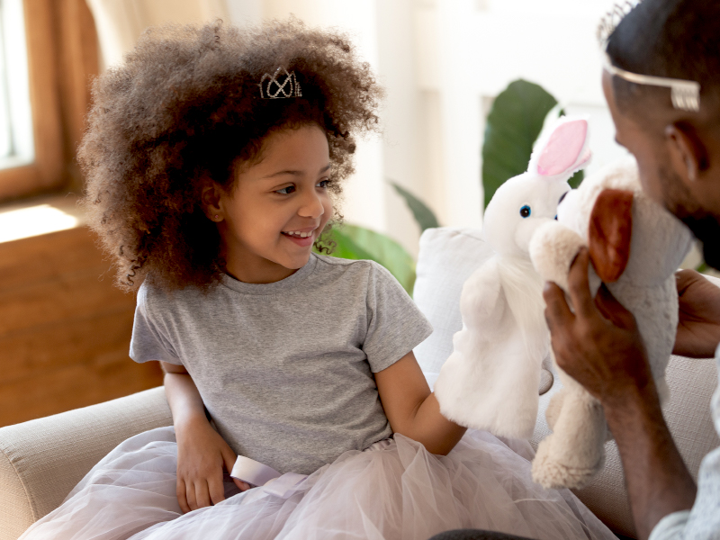 Young girl play acting with father