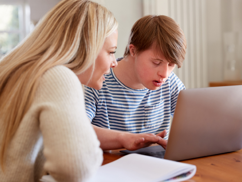 Mom helping son with downs syndrome with homework