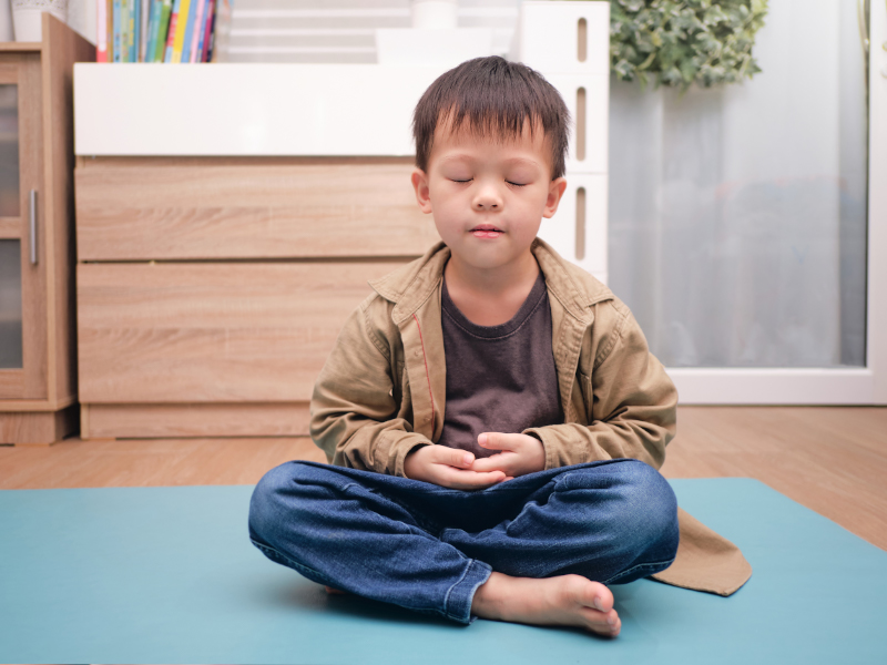 Young Asian boy meditating