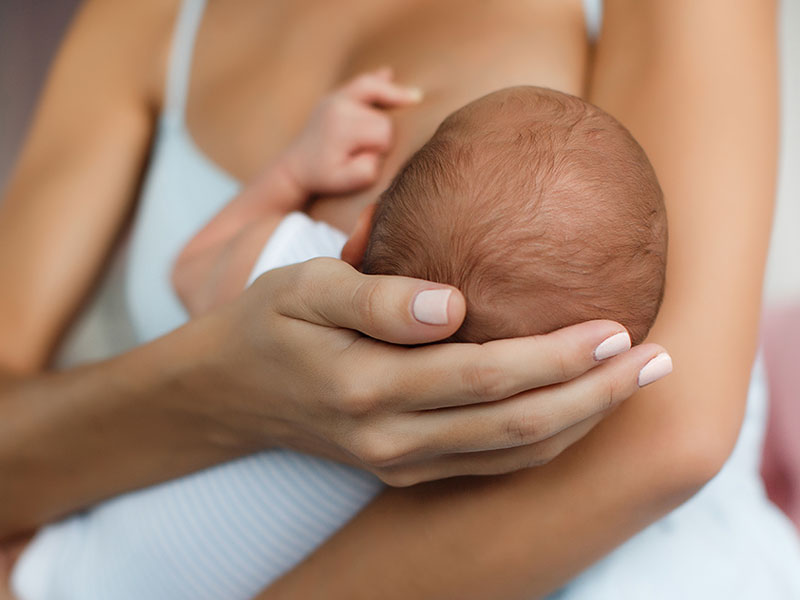 mother breastfeeding newborn baby
