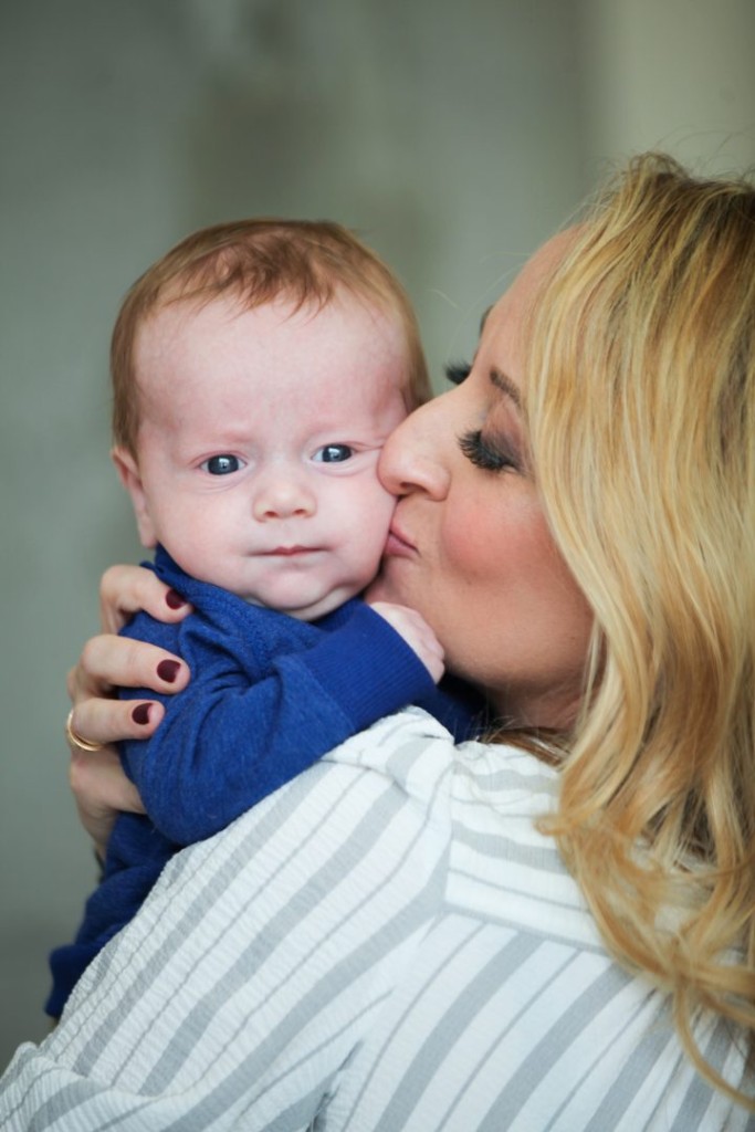 Meteorologist Lauryn Ricketts kissing her infant son Crew on the cheek