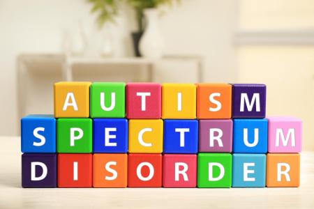 DC Autism Parents – Where Parents Empower Parents Cubes with text AUTISM SPECTRUM DISORDER on table