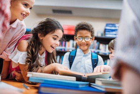 National Reading Month: A book lover’s guide to Washington, DC, for all ages excited little children looking at book in library