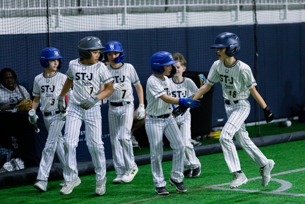 Young baseball player at bat during a clinic drill in the DMV area