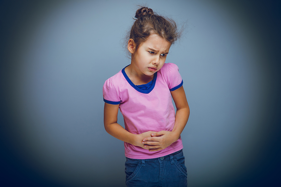 Child stomach pain: When to worry, according to a pediatrician Child with stomach pain holds her abdomen, a common symptom parents worry about