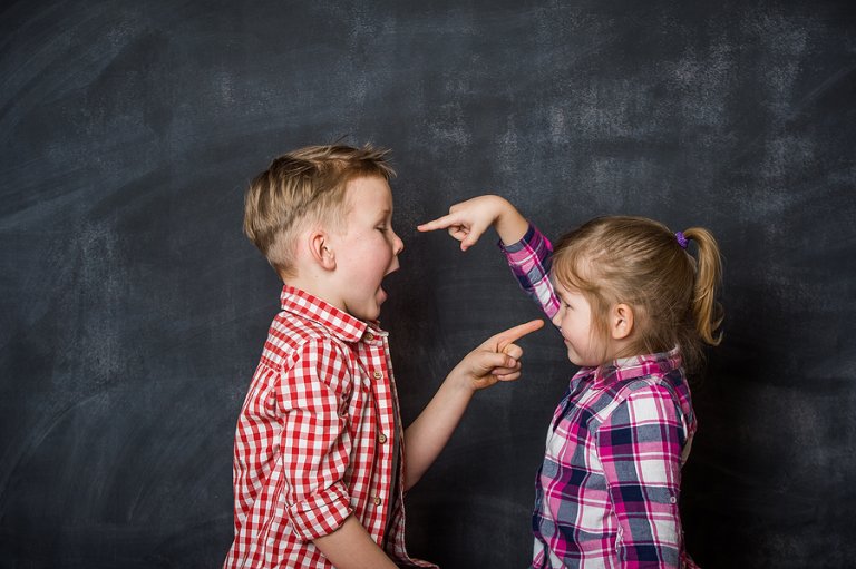 Does your kid play the Blame Game? Here’s what to do Two kids blaming others by pointing fingers at each other.