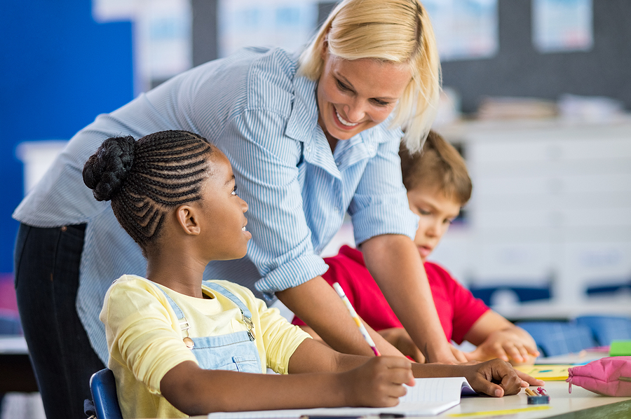 These are the top Fairfax County public and charter schools you should know about A teacher helps students at one of the best public and charter schools in Fairfax County.