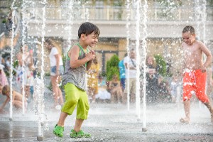 Your summer fun guide to family-friendly events and exploration this July across the DMV Children playing in an outdoor splash pad for the July summer fun guide featuring DMV family events.