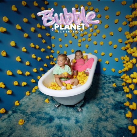 Two children sit in a bathtub surrounded by yellow rubber ducks at Bubble Planet DC