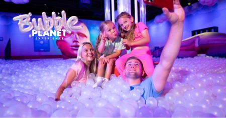 Family plays in a colorful foam bubble pit at Bubble Planet DC.