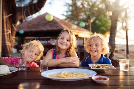 10 restaurants in the DMV where kids eat free Children sharing a meal outdoors at a DMV restaurant where kids eat free