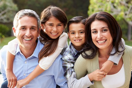 Smiling family of four outdoors for Fun Things to Do With Kids in the DMV This Weekend.