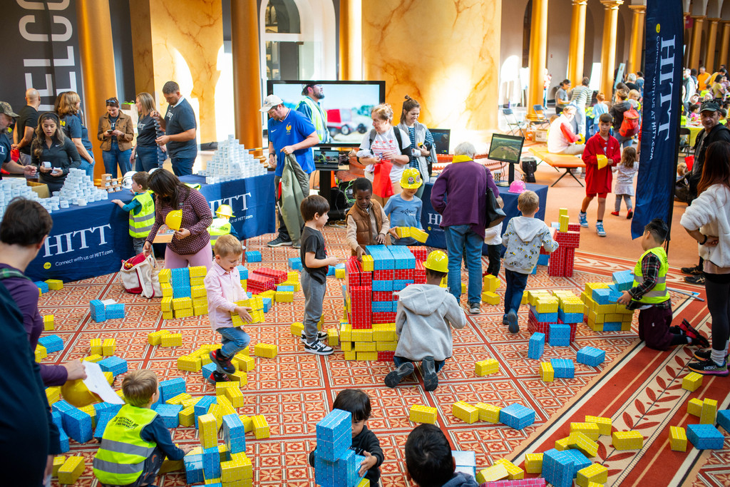 Children build with giant cardboard bricks in the Great Hall during The Big Build National Building Museum festival in DC.
